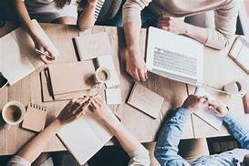 a group of writers gathered around a table