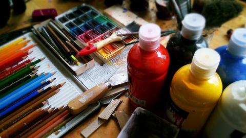 An assortment of paintbrushes and paint bottles