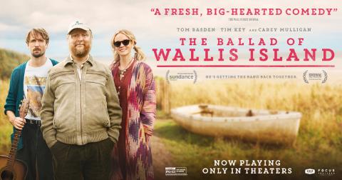 Movie poster for the film The Ballad of Wallis Island, with three people standing side by side, facing the camera, a thin hip man on the left, a gregarious looking man in the middle, and a cool female with sunglasses to his right, with the title of the movie to the right of the group