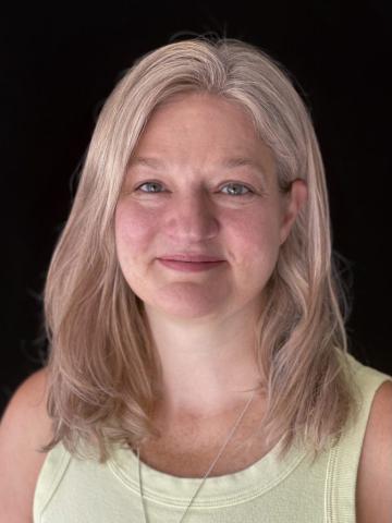 Headshot of Tina Rounds, BEDS Plus CEO on a black background