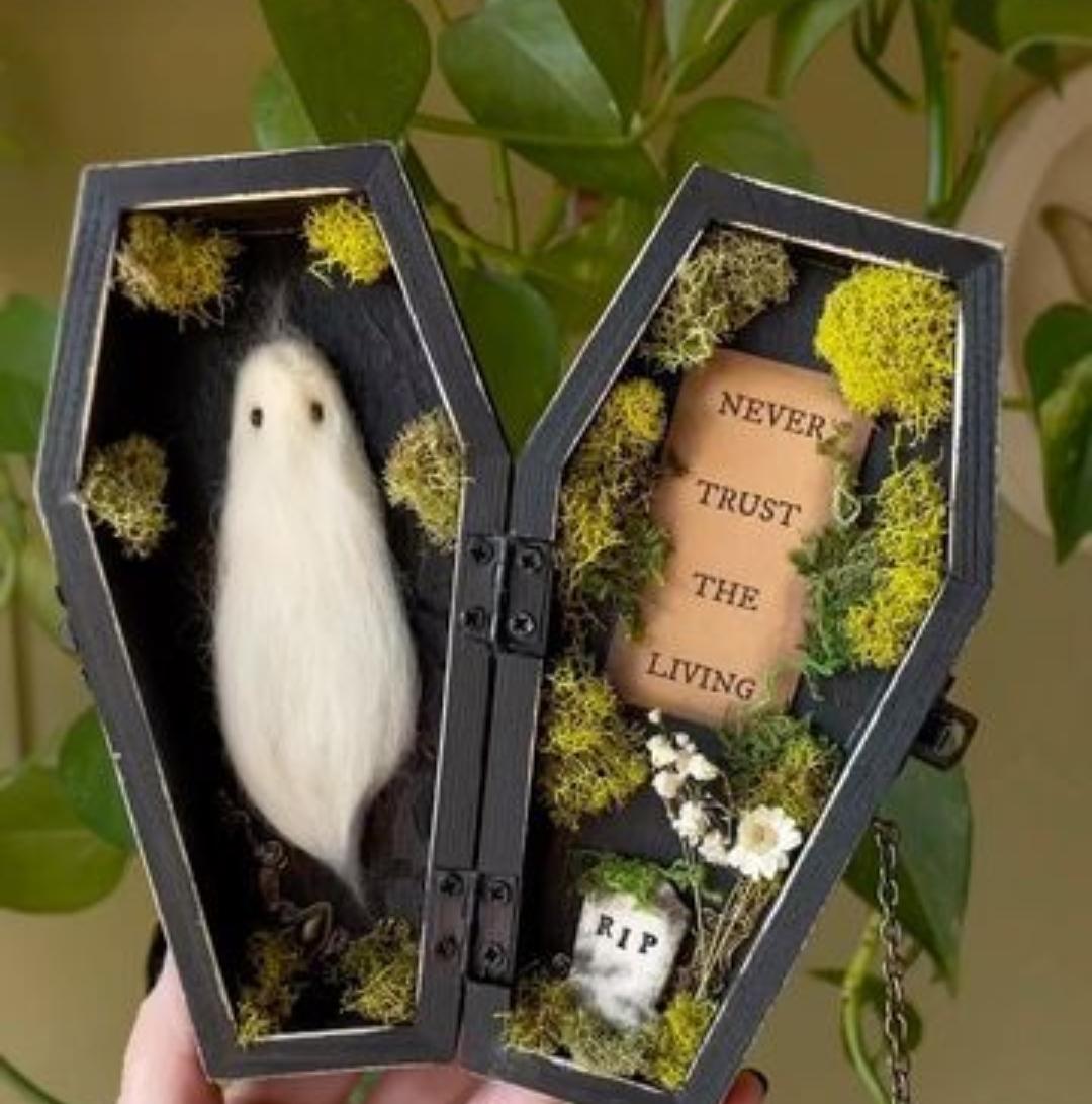 A ghost and a gravestone in little coffins