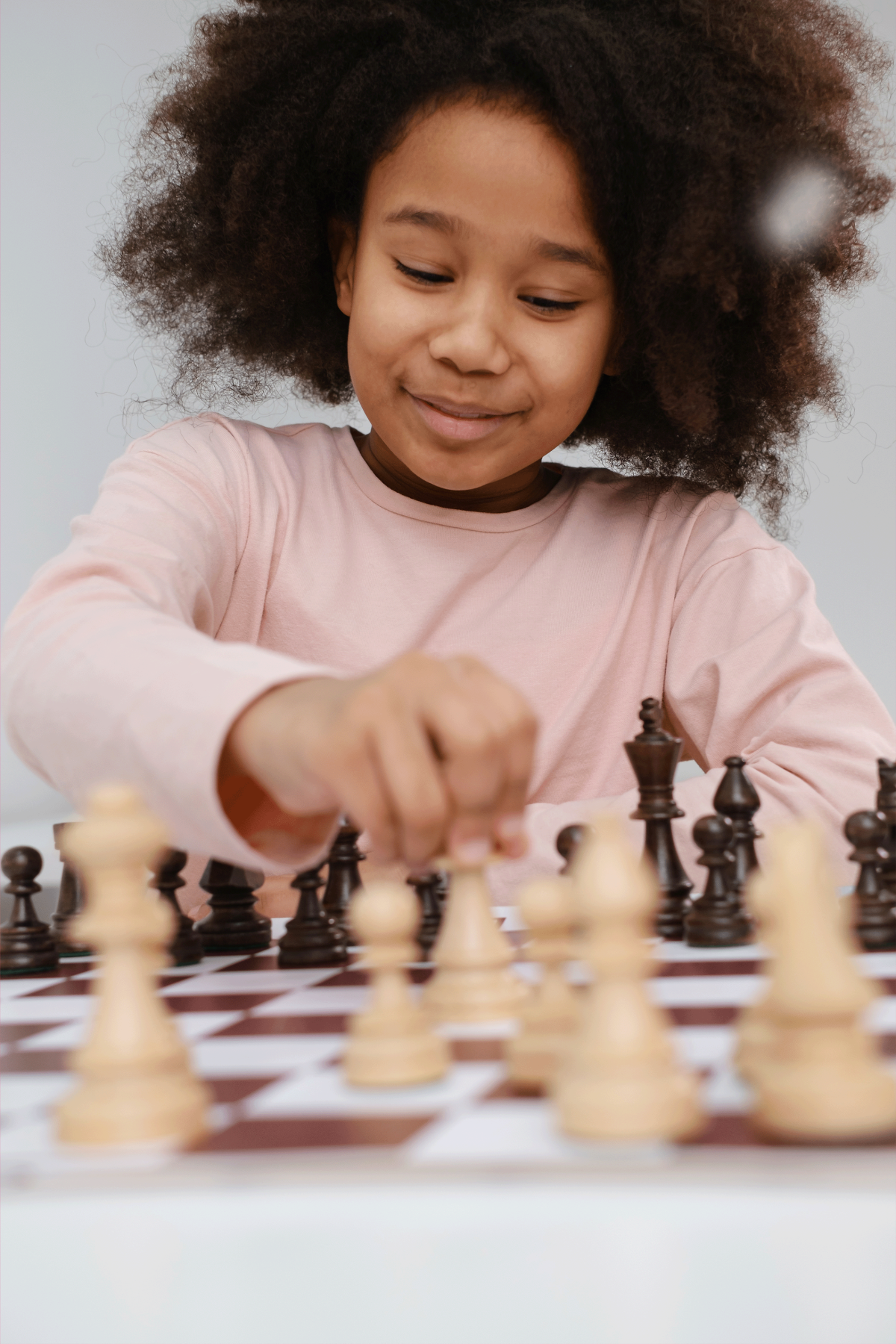 Young girl at a chess board