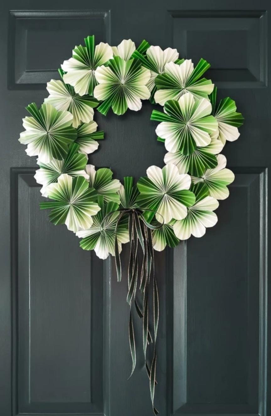 A wreath of paper clovers with black ribbons hanging from the bottom